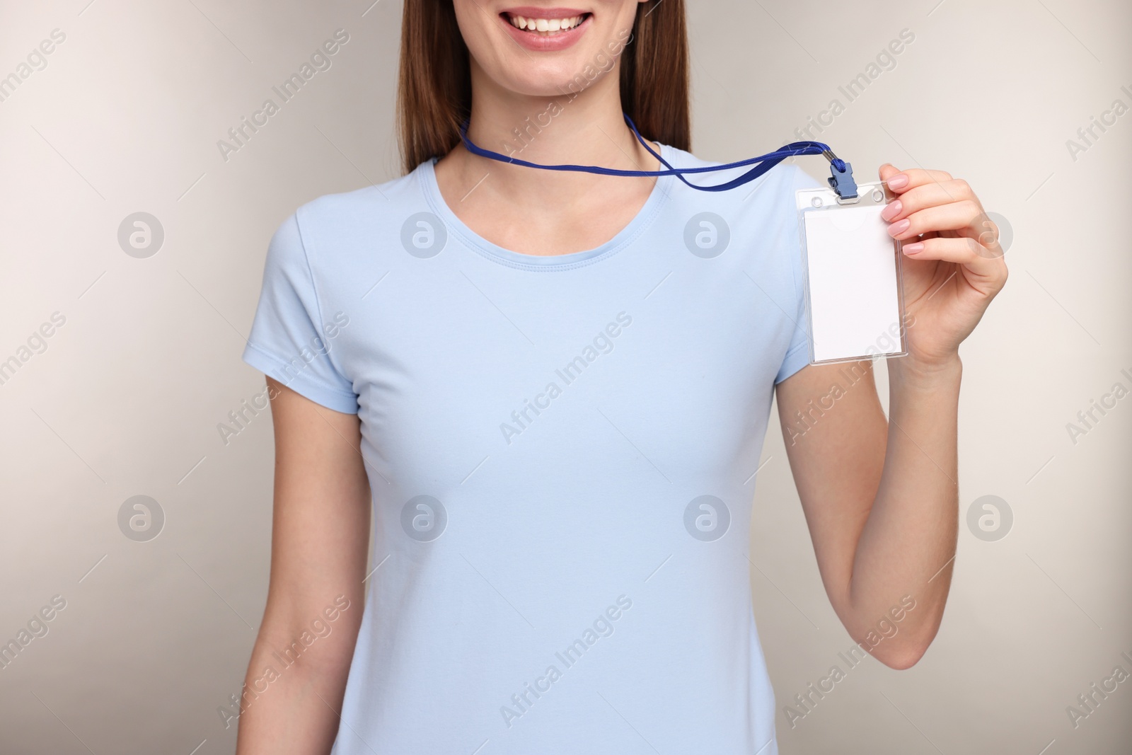 Photo of Woman with blank badge on grey background, closeup