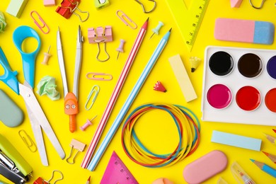 Photo of Flat lay composition with different school stationery on yellow background. Back to school