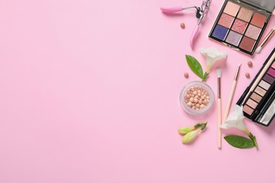 Flat lay composition with eyeshadow palettes and beautiful flowers on pink background, space for text