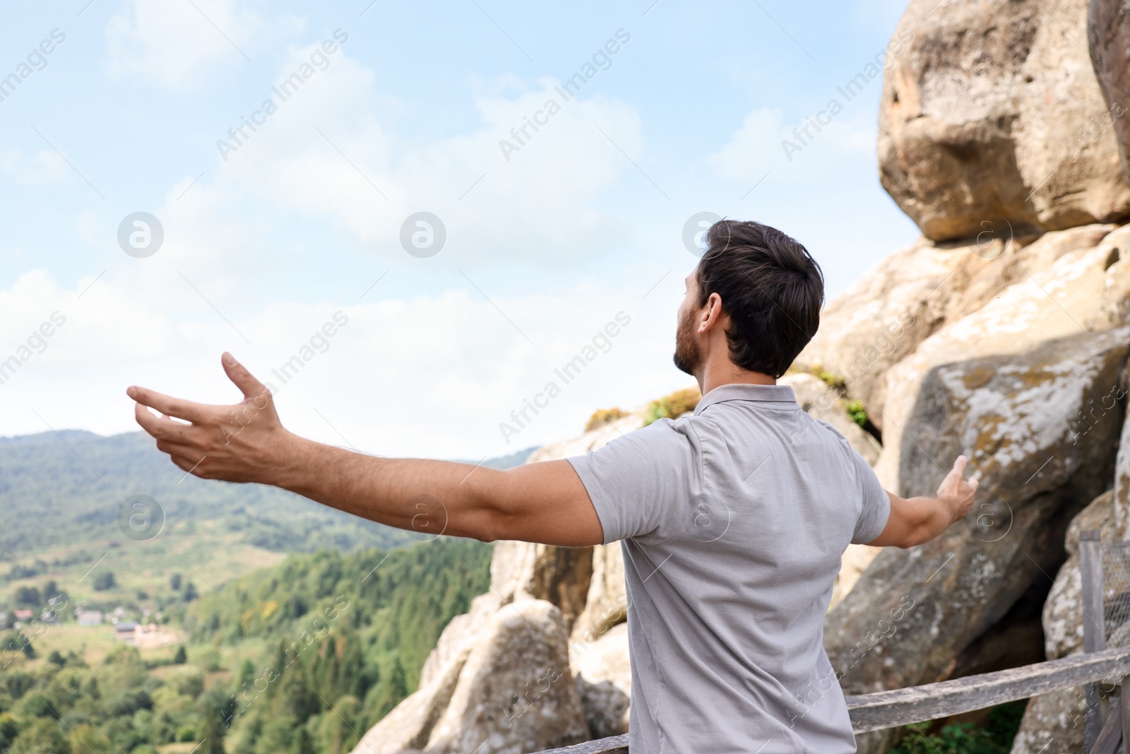 Photo of Feeling freedom. Man with wide open arms in mountains