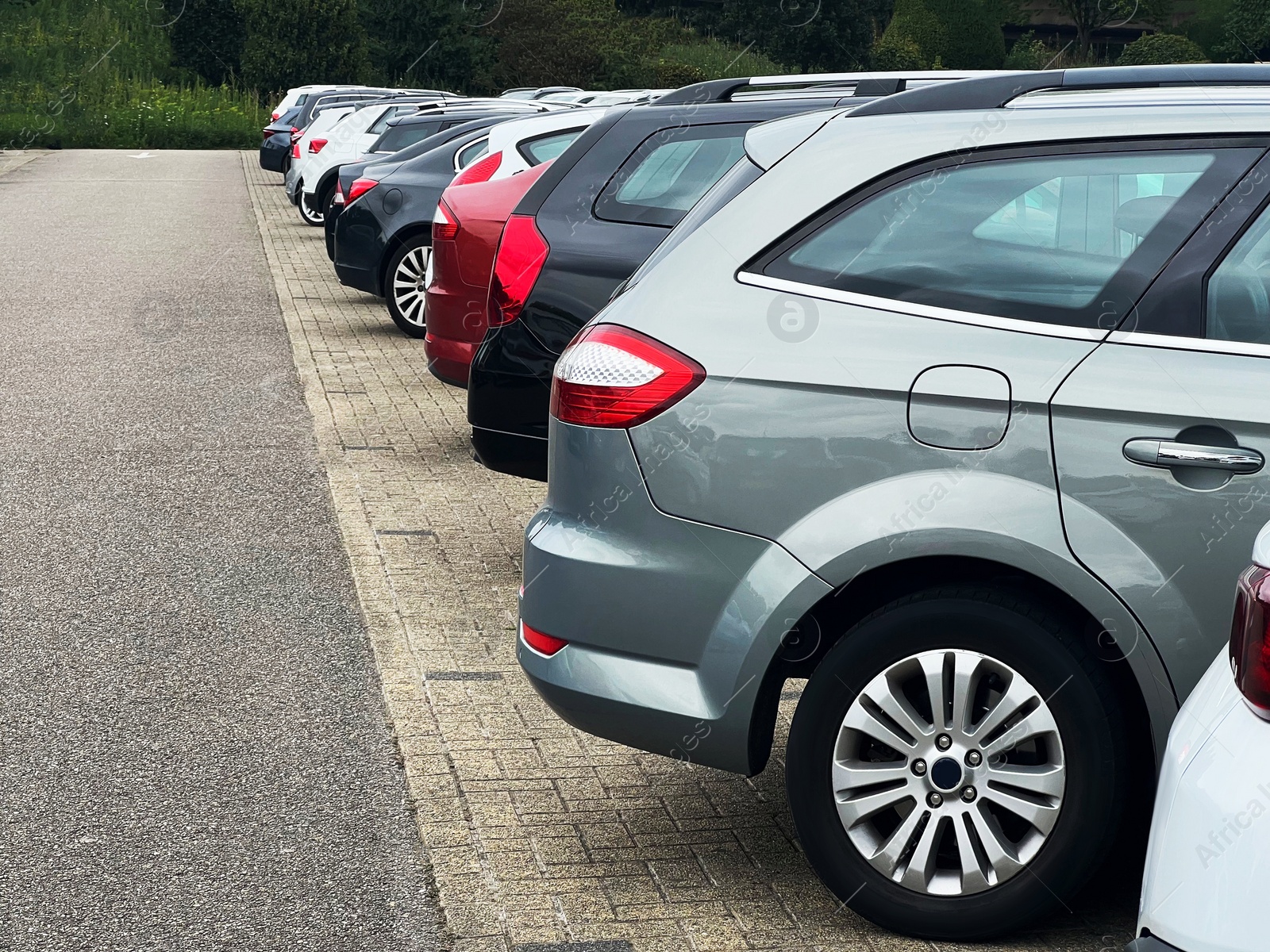 Photo of View of many different cars parked near road