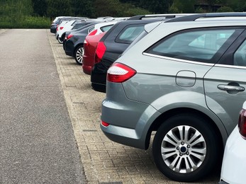 View of many different cars parked near road