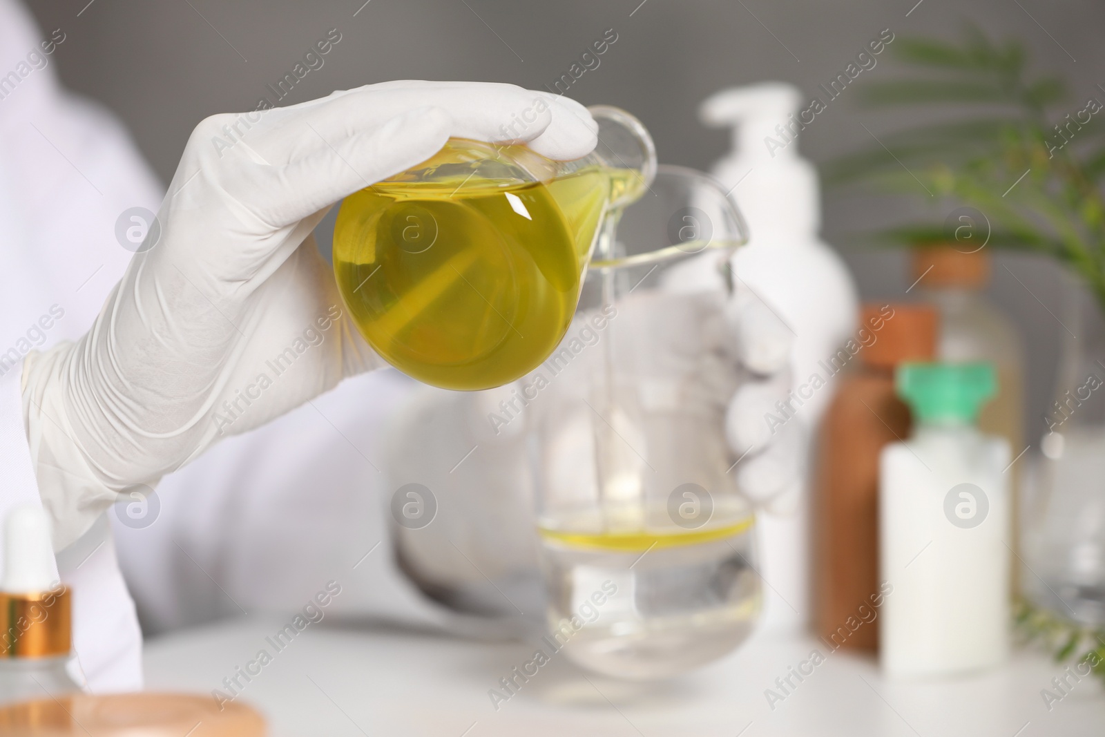 Photo of Dermatologist developing cosmetic product indoors, selective focus