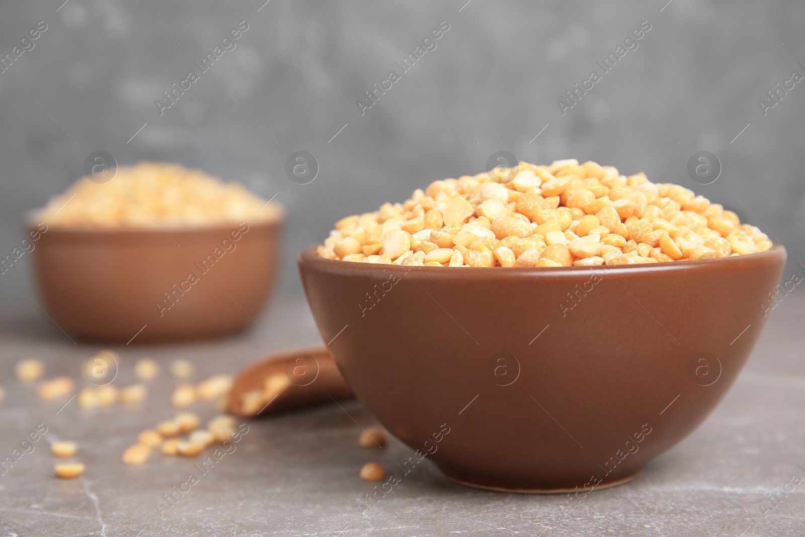 Photo of Ceramic bowl with dried peas on table