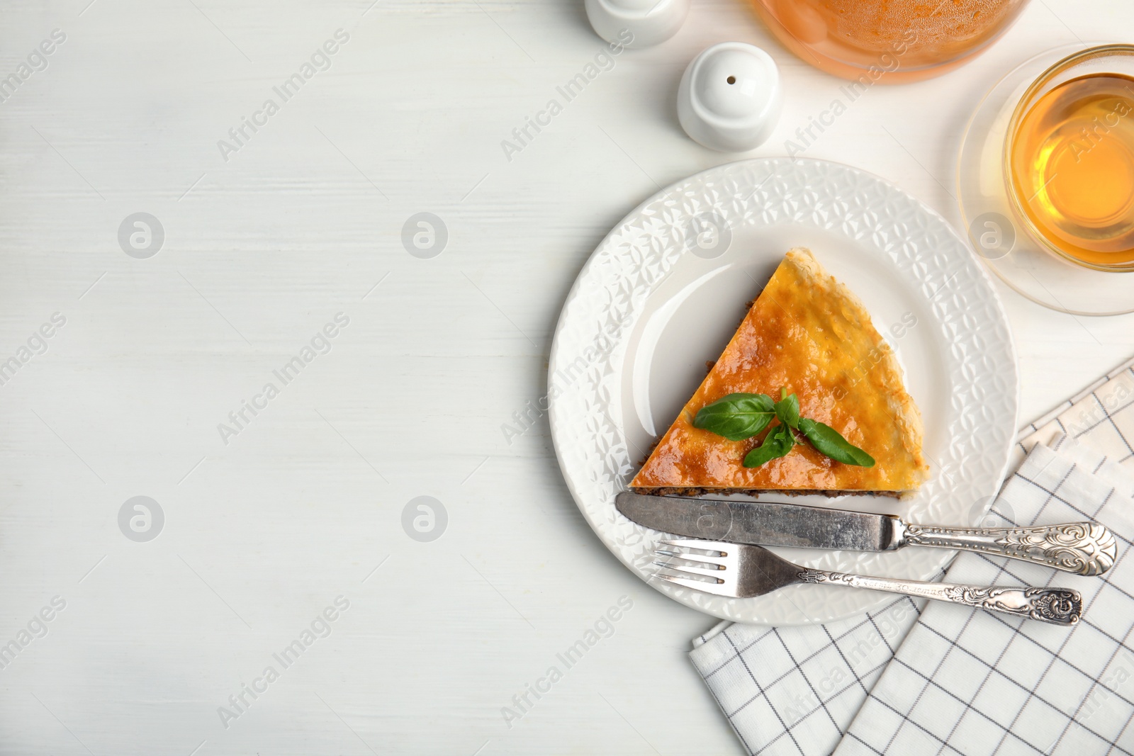 Photo of Piece of delicious pie with minced meat on white wooden table, flat lay. Space for text