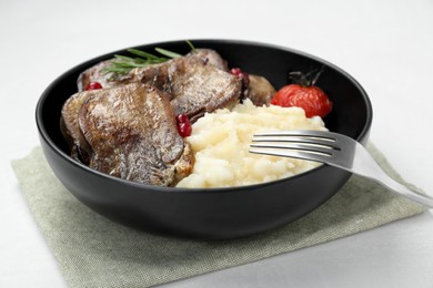 Photo of Tasty beef tongue pieces, berries, rosemary, mashed potatoes and tomato on white table, closeup