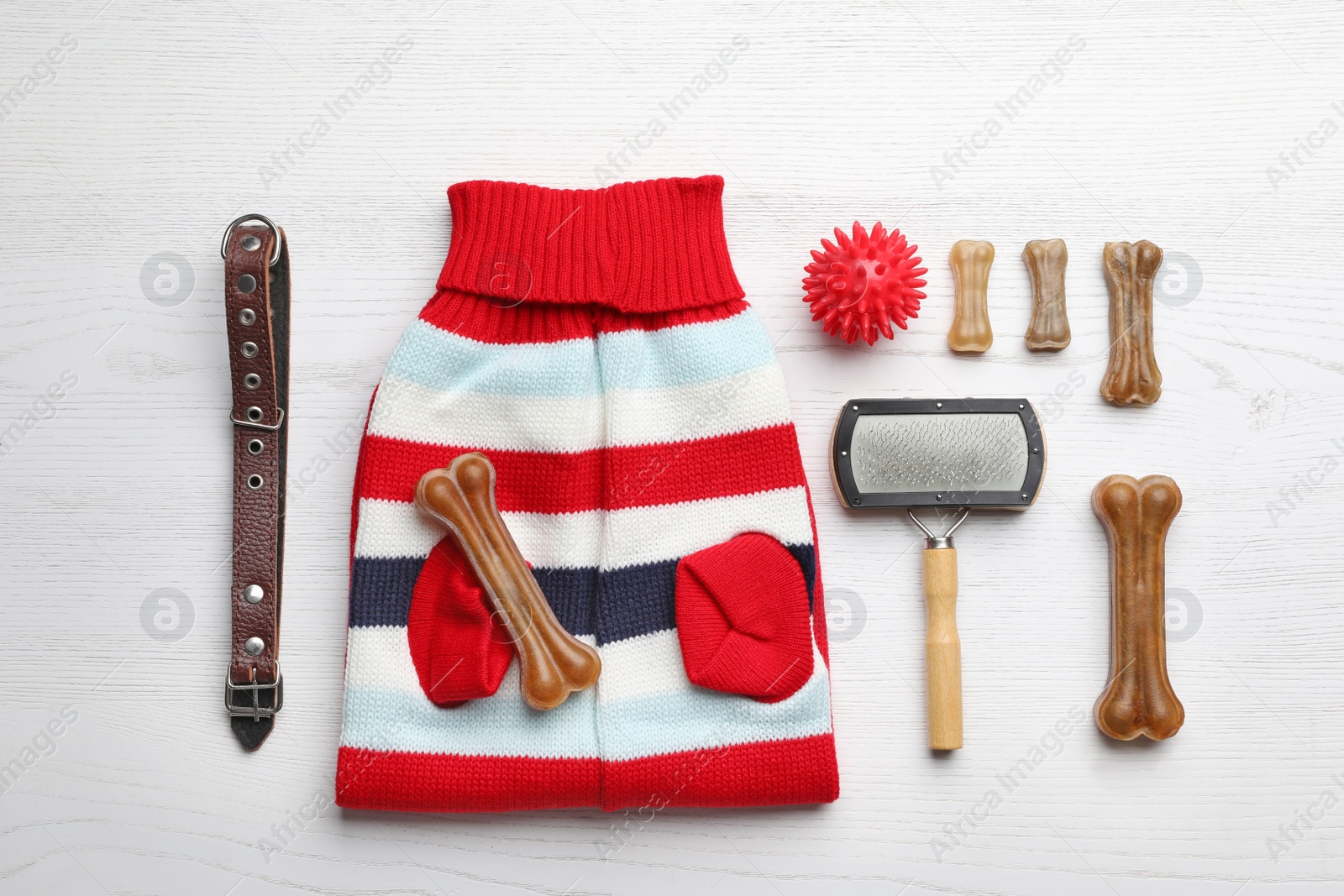 Photo of Flat lay composition with clothes, food and accessories for dog on white wooden table