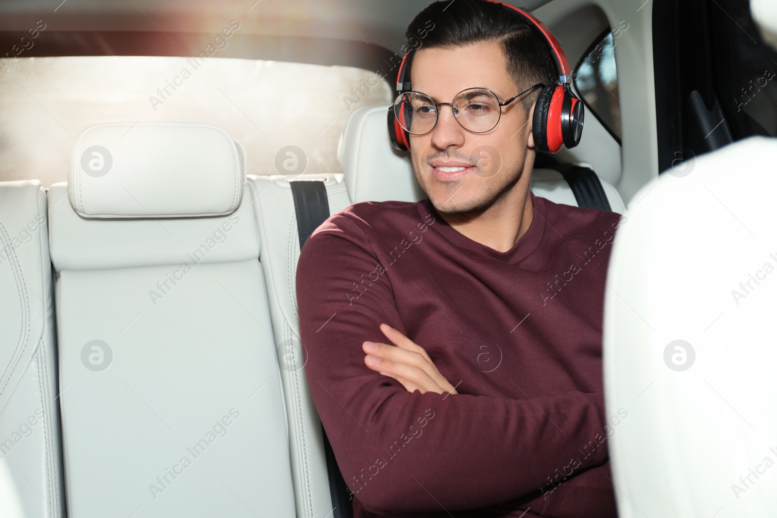 Photo of Handsome man listening to audiobook in car