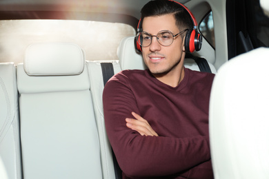 Handsome man listening to audiobook in car