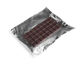 Delicious dark chocolate bar with foil isolated on white