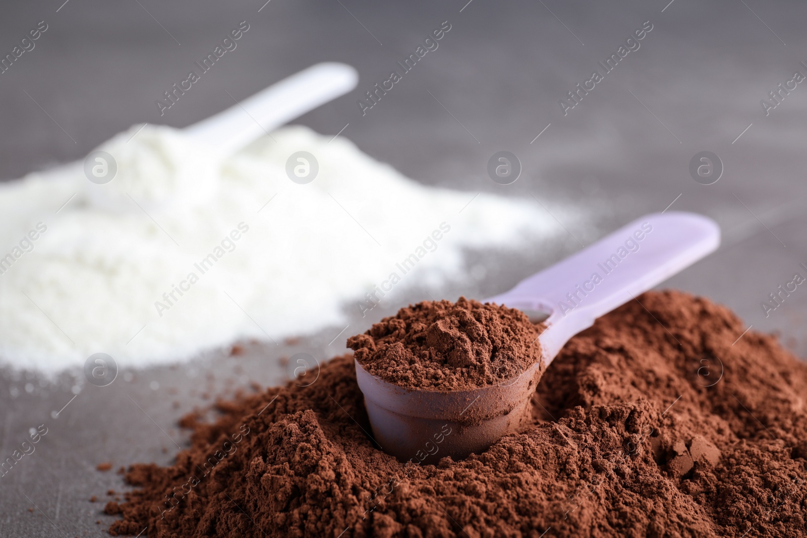 Photo of Scoop of protein powder on table, space for text