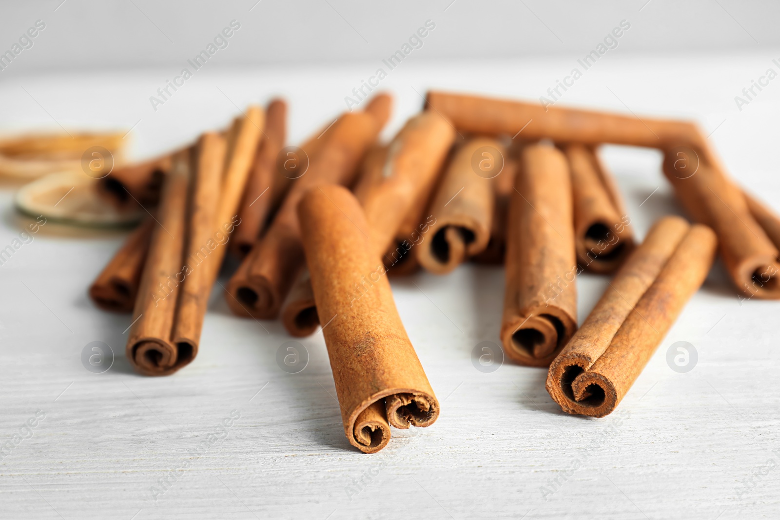 Photo of Aromatic cinnamon sticks on wooden background