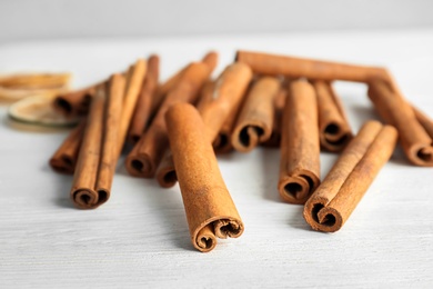 Photo of Aromatic cinnamon sticks on wooden background