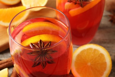 Photo of Aromatic punch drink on wooden table, closeup