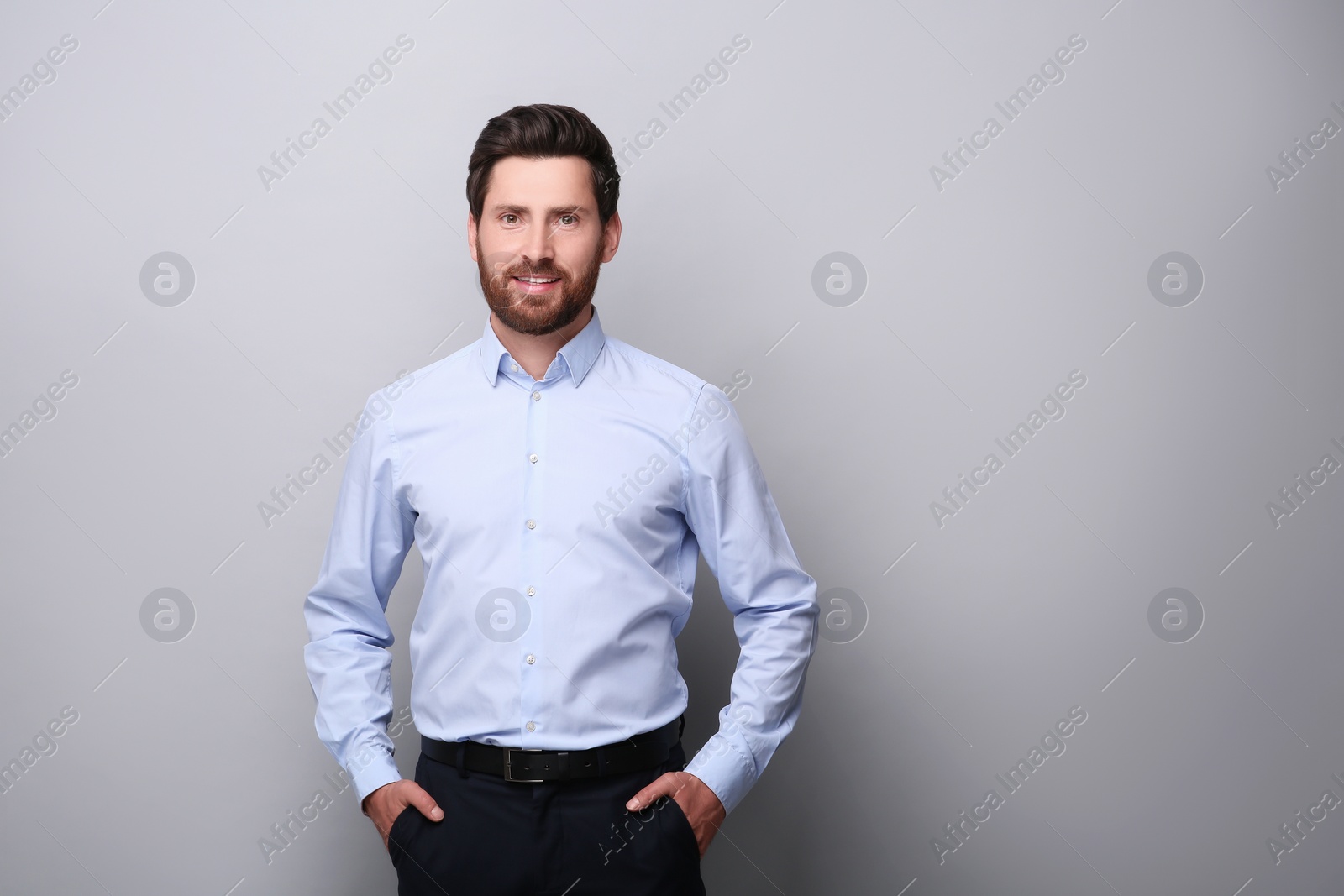 Photo of Portrait of handsome man on light grey background, space for text