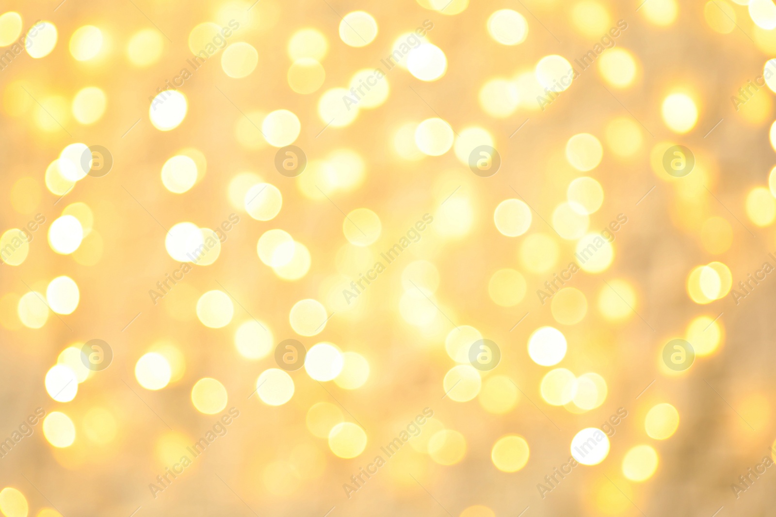 Photo of Blurred view of golden Christmas lights as background. Bokeh effect