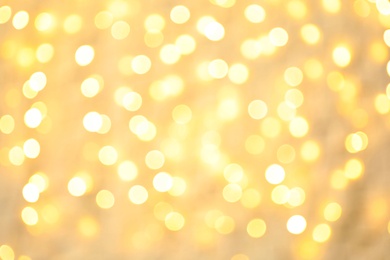 Photo of Blurred view of golden Christmas lights as background. Bokeh effect