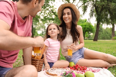 Photo of Happy family having picnic in park on summer day