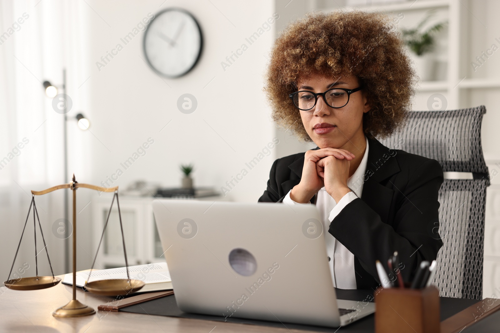 Photo of Notary using laptop at workplace in office