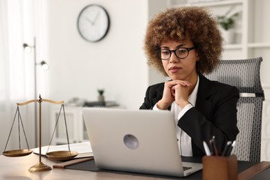 Notary using laptop at workplace in office