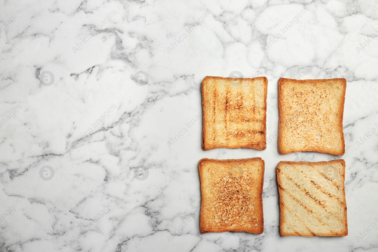 Photo of Toasted bread on light background, top view