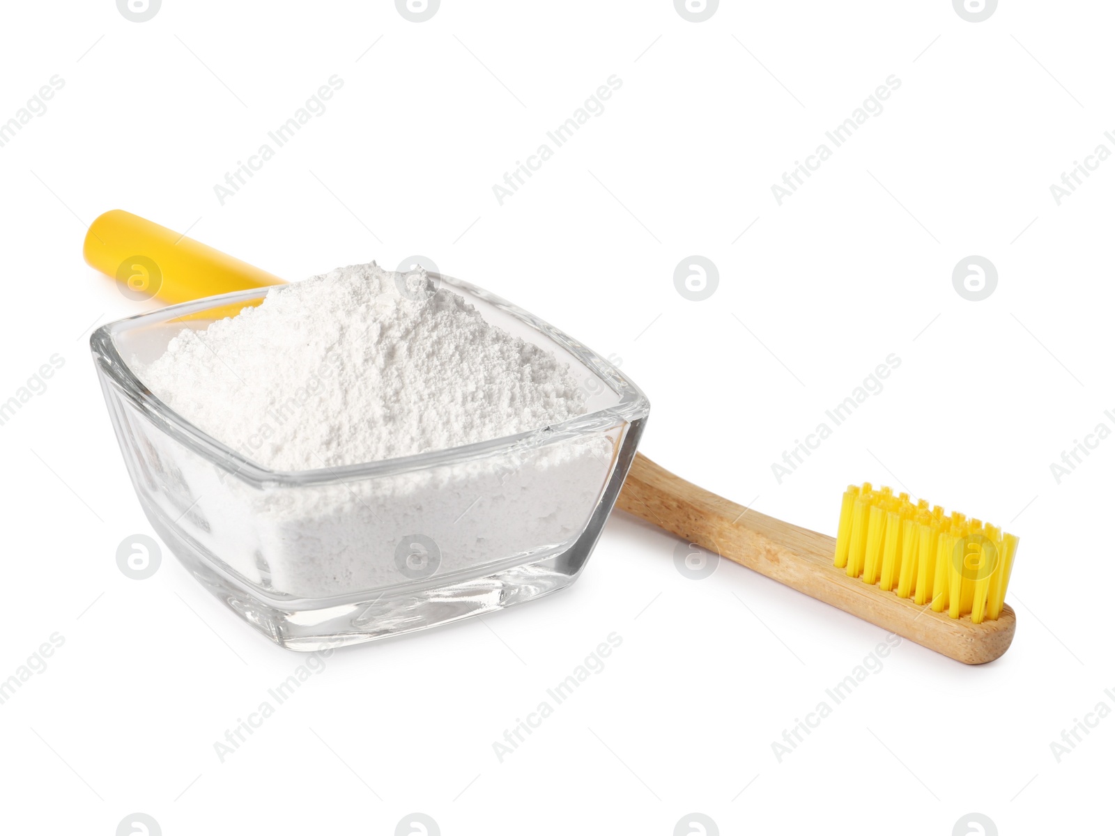 Photo of Glass bowl of tooth powder and brush on white background