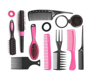 Photo of Set of modern hair combs and brushes and spiral rubber bands isolated on white, top view