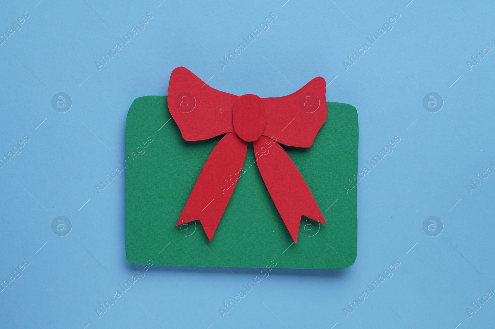 Photo of Paper gift box on light blue background, top view