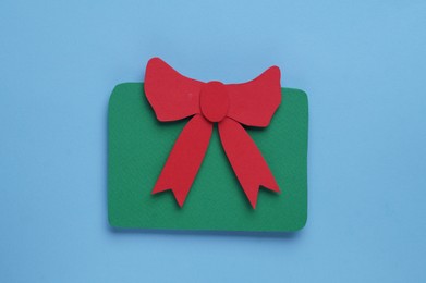 Paper gift box on light blue background, top view