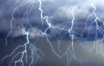 Lightnings in dark cloudy sky during thunderstorm