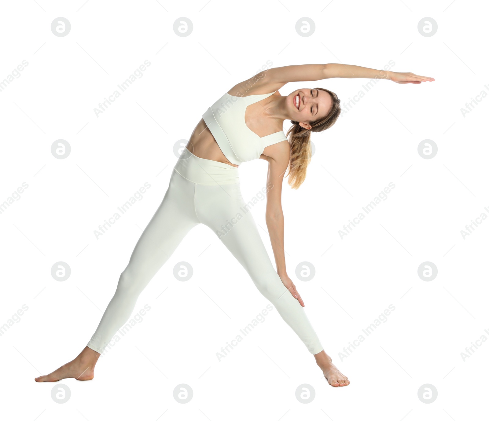 Photo of Young woman in sportswear practicing yoga on white background