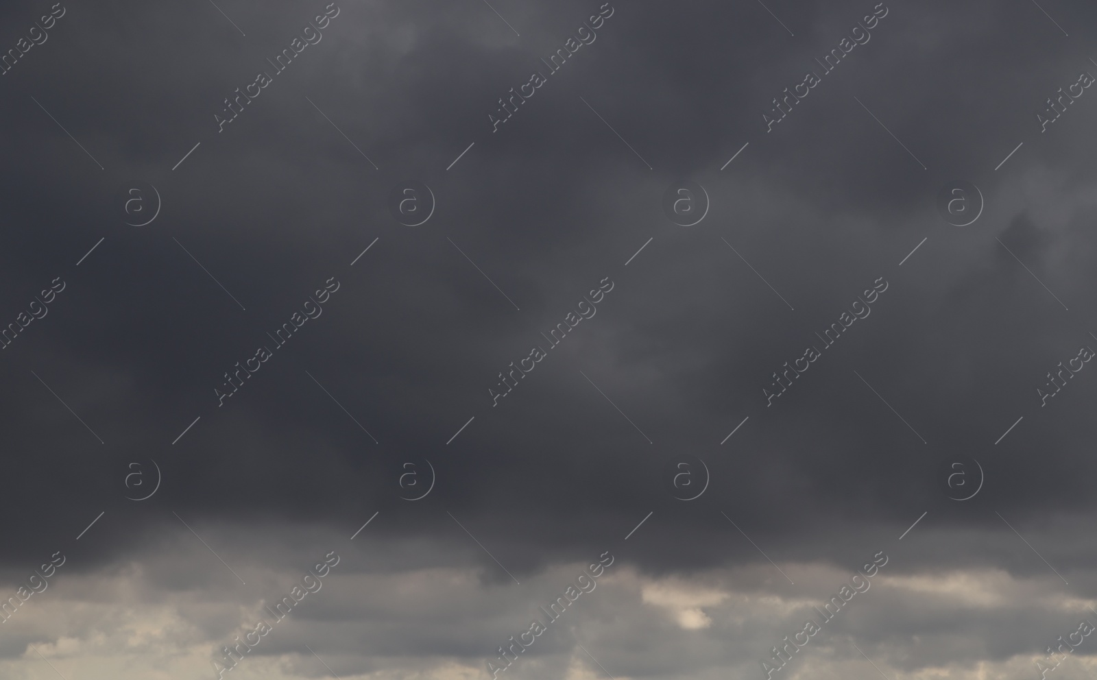 Photo of Sky with heavy rainy clouds on grey day