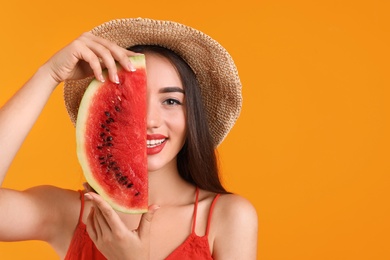 Beautiful young woman posing with watermelon on color background