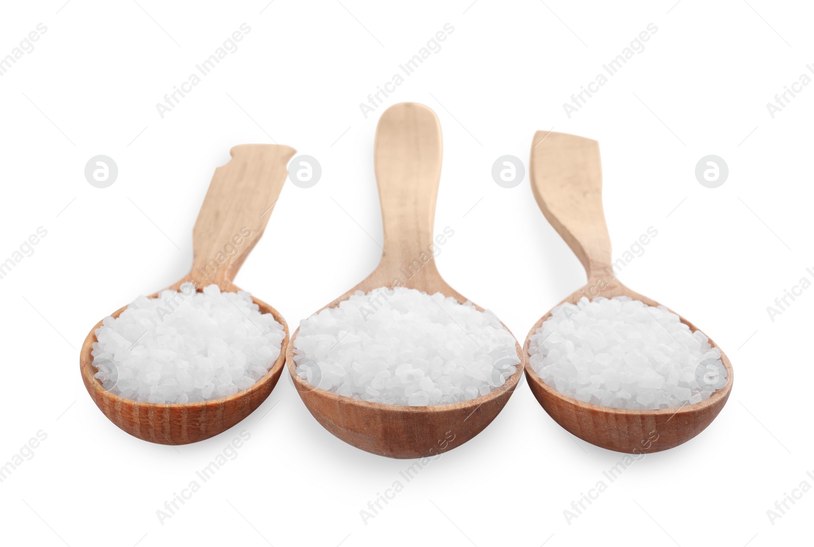 Photo of Wooden spoons with natural sea salt isolated on white