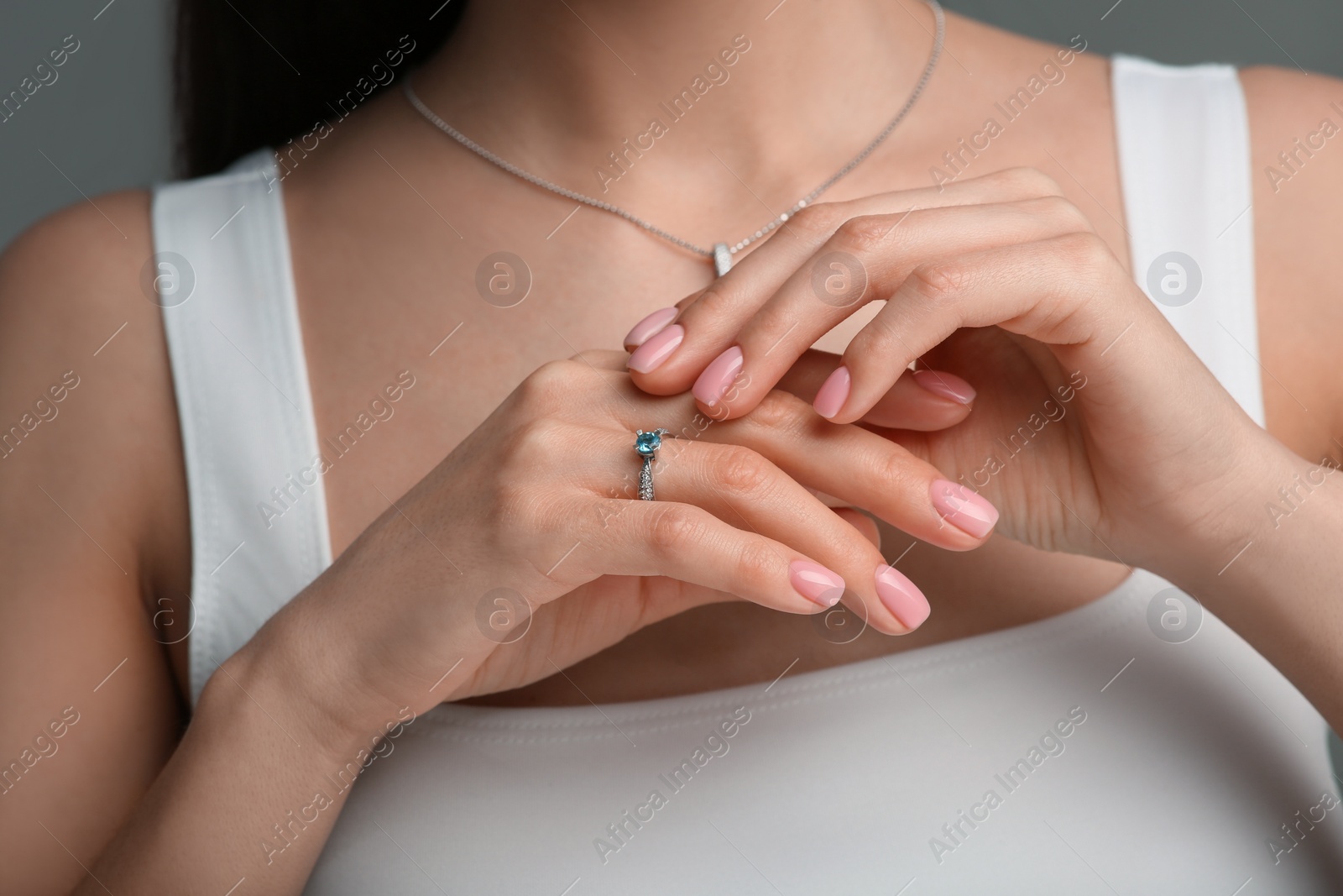 Photo of Woman with elegant jewelry on dark grey background, closeup