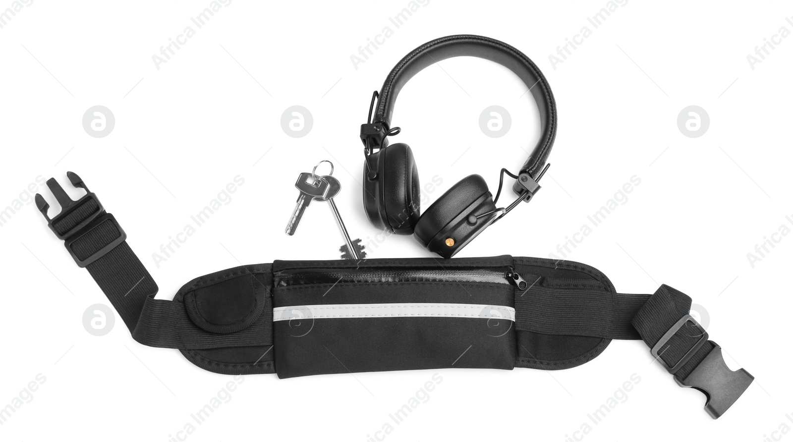 Photo of Stylish black waist bag, headphones and keys isolated on white, top view