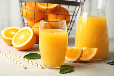 Photo of Composition with orange juice and fresh fruit on table