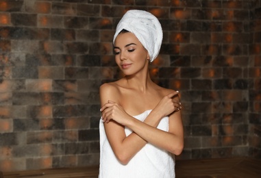 Photo of Portrait of young woman in salt sauna at luxury spa center