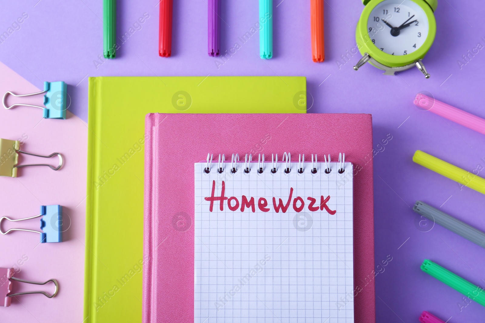 Photo of Flat lay composition of notebook with word HOMEWORK on color background