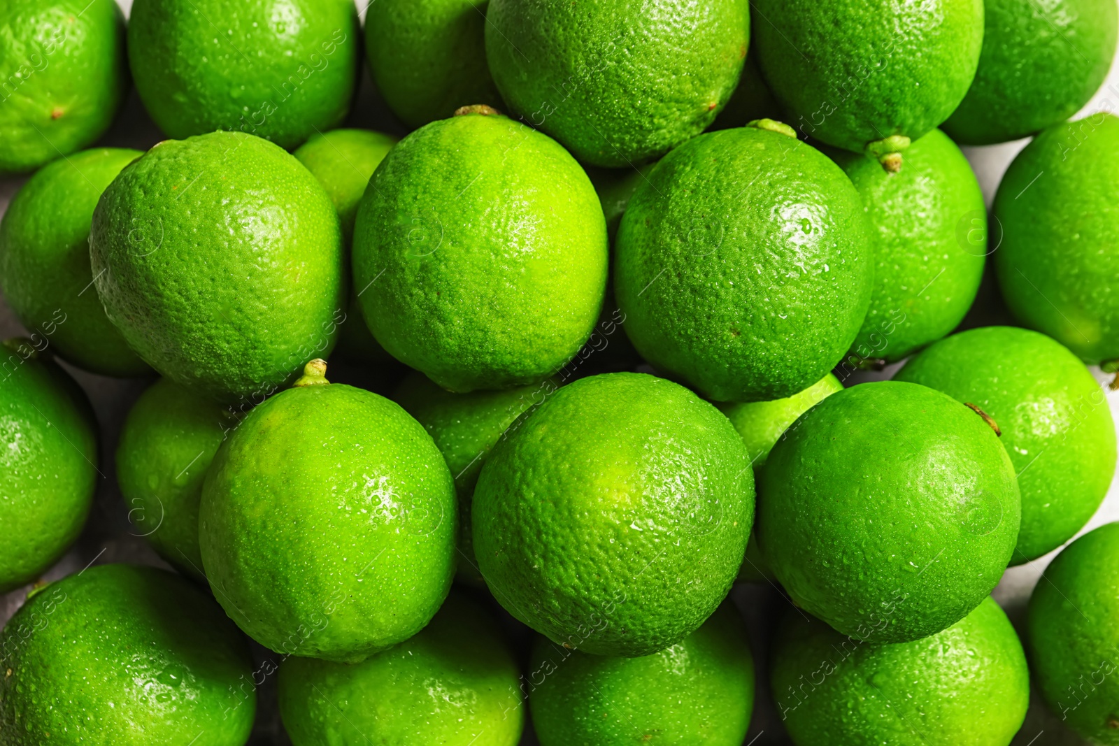 Photo of Fresh ripe green limes as background