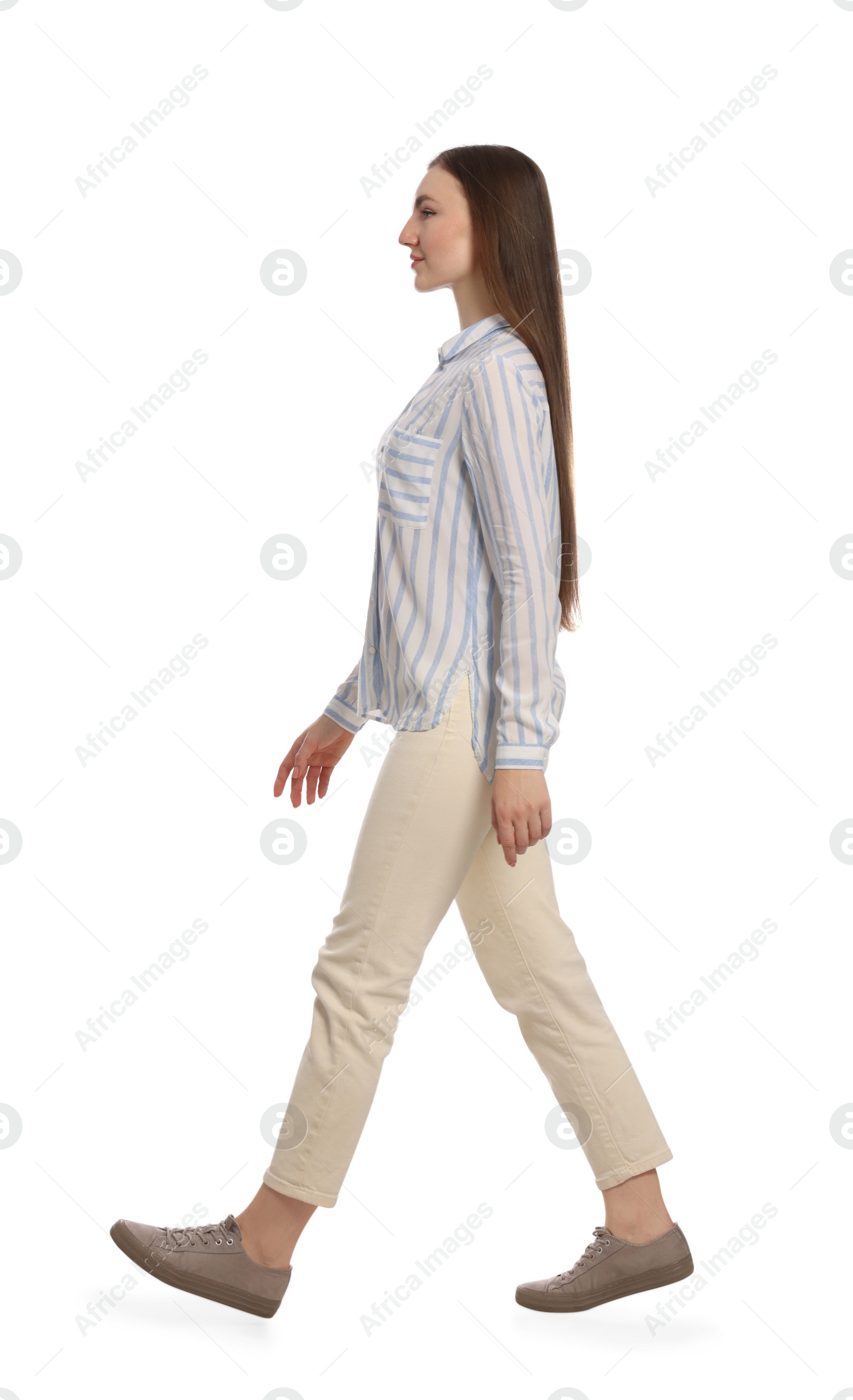 Photo of Young woman in casual outfit walking on white background