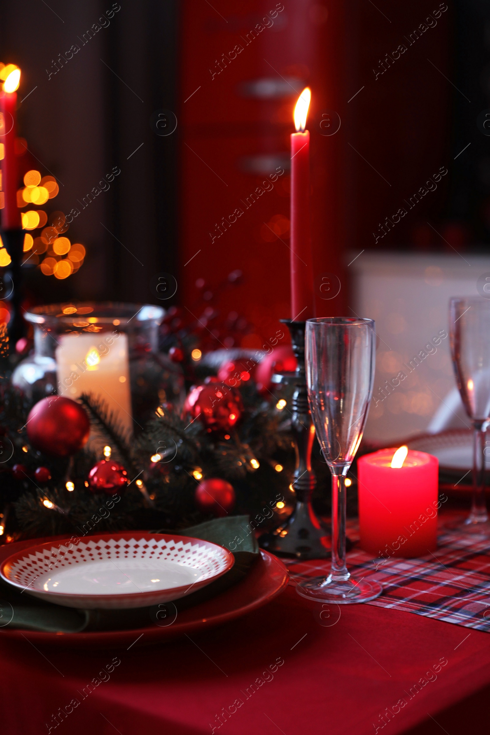 Photo of Table served for festive dinner and Christmas tree in stylish kitchen interior