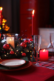 Photo of Table served for festive dinner and Christmas tree in stylish kitchen interior