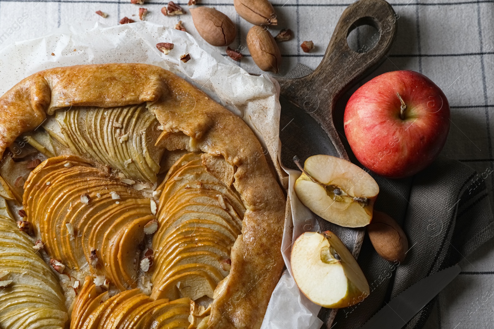 Photo of Delicious apple galette with pecans on table, flat lay