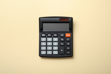 Calculator on beige background, top view. Office equipment