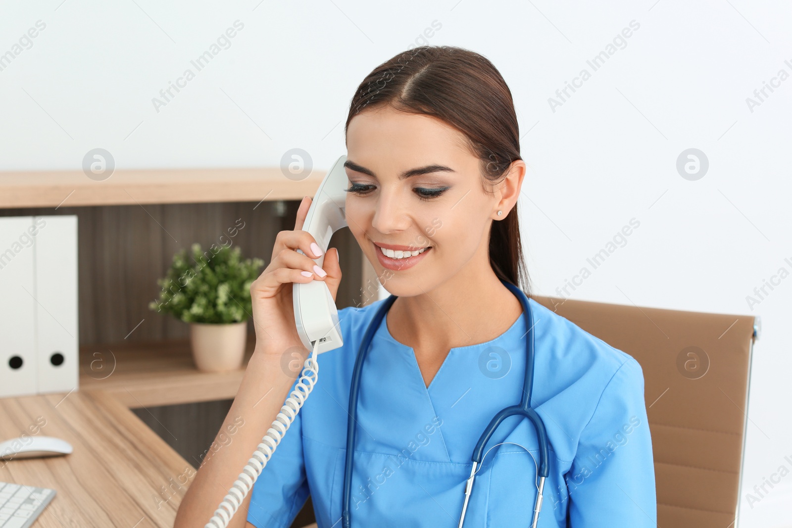 Photo of Female medical assistant at workplace in clinic. Health care service