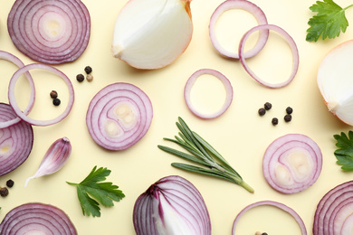 Photo of Flat lay composition with onion and spices on beige background