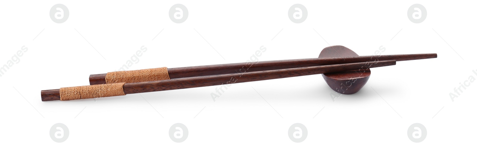 Photo of Pair of wooden chopsticks with rest isolated on white