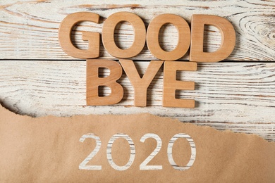 Flat lay composition with phrase Goodbye 2020 on white wooden table