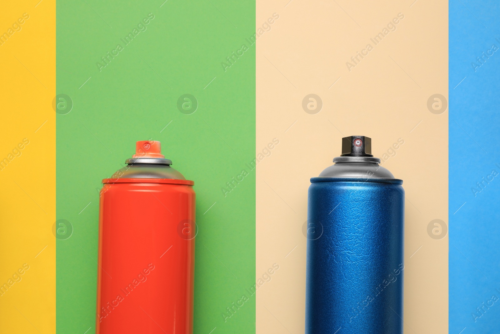 Photo of Cans of different spray paints on color background, flat lay with space for text. Graffiti supplies